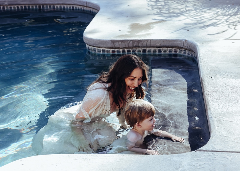 mom and son play in the pool captured during golden hour by bella luna photography