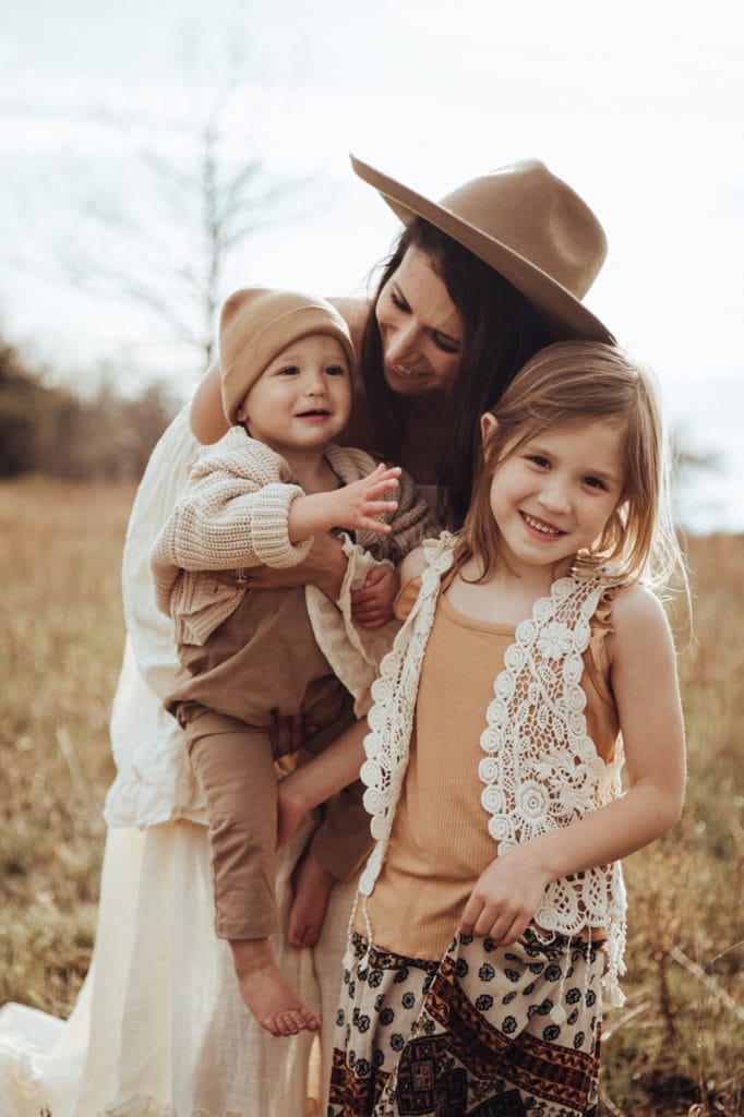 Family, Maternity & Studio Photographer, Mom holds her son and smiles, while her daughter looks at the camera, captured by Bella Luna Photography at Rust Mannor
