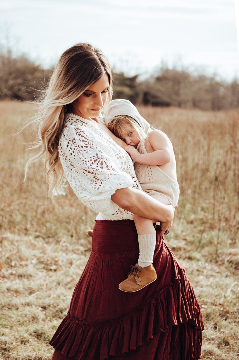 mom breastfeeds daughter captured during golden hour session by bella luna photography