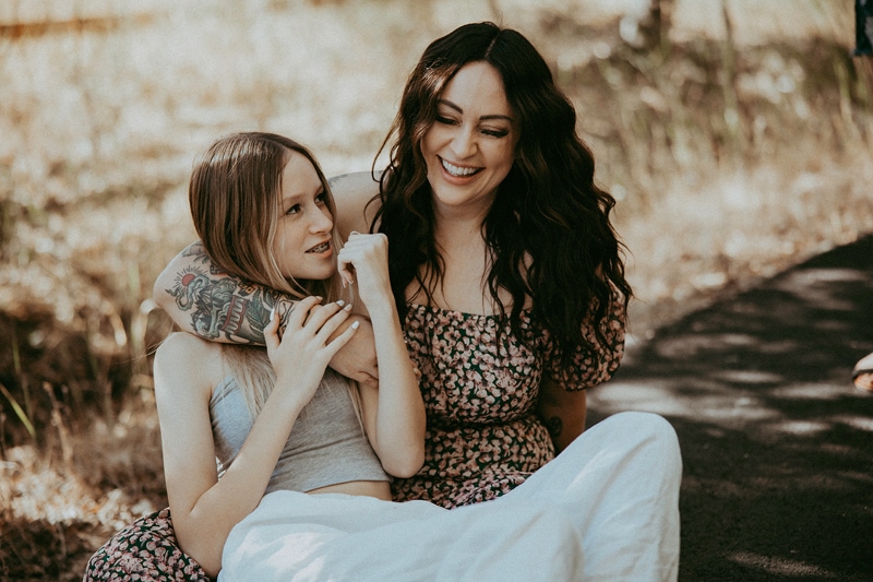 mom hugs daughter and laugh during  family photoshoot by bella luna photography