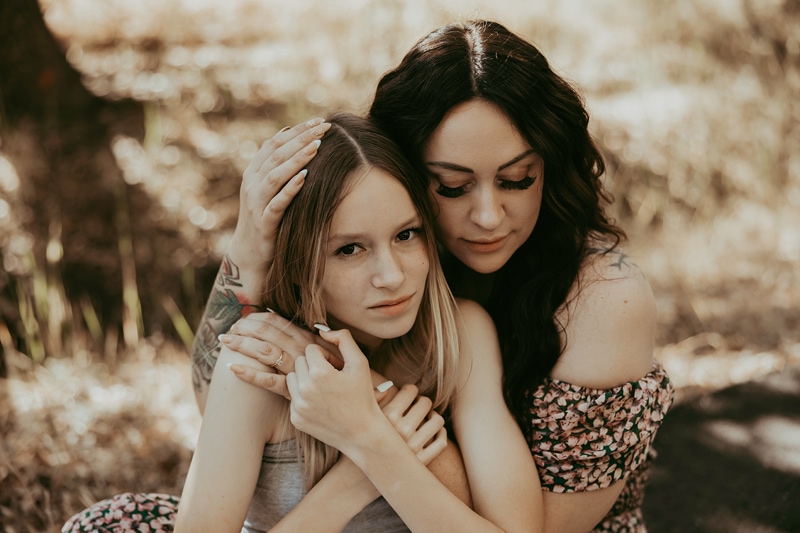 Mom hugs daughter during a family photoshoot